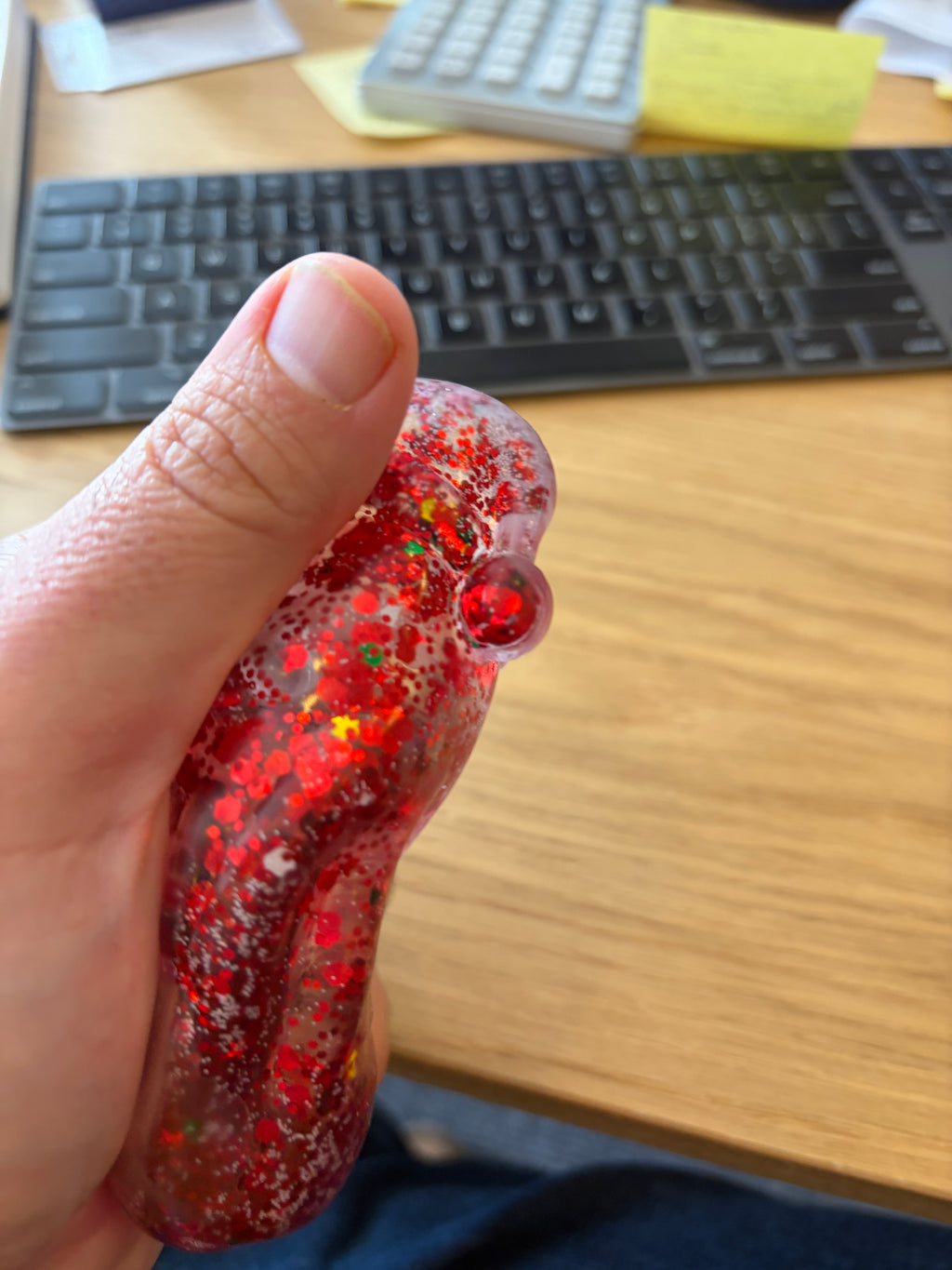 Actual Feelzies Santa Christmas Squishy held and compressed in an adult hand